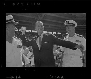 Unidentified man with naval officers throwing ceremonial first pitch at Fenway Park