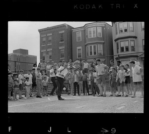 Mayor Kevin White takes his turn at bat during walking tour of East Boston prior to dedication of first neighborhood city hall