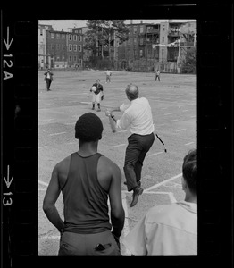Mayor Kevin White takes his turn at bat during walking tour of East Boston prior to dedication of first neighborhood city hall
