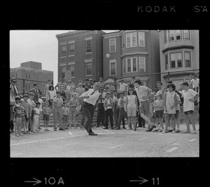 Mayor Kevin White takes his turn at bat during walking tour of East Boston prior to dedication of first neighborhood city hall