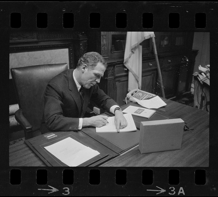 Mayor-elect Kevin White writing his resignation as Massachusetts Secretary of State