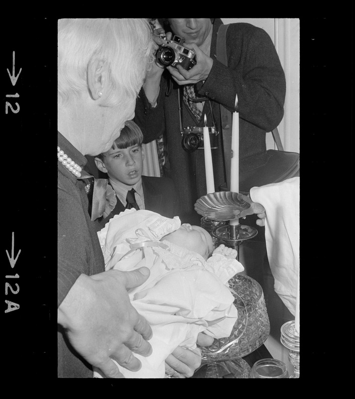 Mrs. Lawrence Cameron holding Patricia Hagan White at her christening in the home of Boston Mayor Kevin White