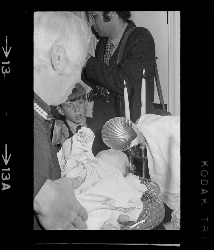 Mrs. Lawrence Cameron holding Patricia Hagan White at her christening in the home of Boston Mayor Kevin White