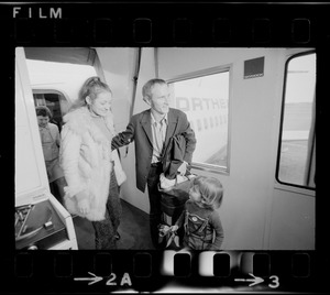 Elisabeth Neumann, freed recently from East German prison, and her fiancé, Lyle Jenkins, MIT student who flew to Germany to meet her on her release, are greeted at Logan Airport by Jenkins' nephew, Saarin Auker, 3, of Cambridge, a bearer of red roses