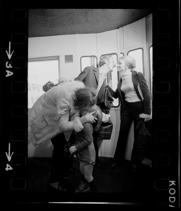 Elisabeth Neumann, freed recently from East German prison, and her fiancé, Lyle Jenkins, MIT student who flew to Germany to meet her on her release, are greeted at Logan Airport by Jenkins' nephew, Saarin Auker, 3, of Cambridge, a bearer of red roses