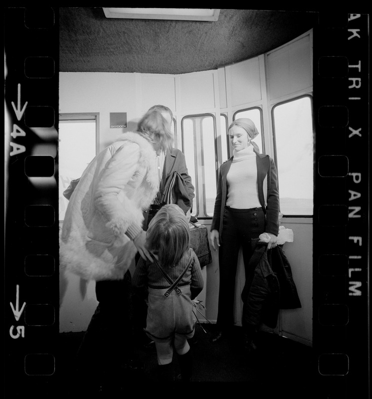 Elisabeth Neumann, freed recently from East German prison, and her fiancé, Lyle Jenkins, MIT student who flew to Germany to meet her on her release, are greeted at Logan Airport by Jenkins' nephew, Saarin Auker, 3, of Cambridge, a bearer of red roses