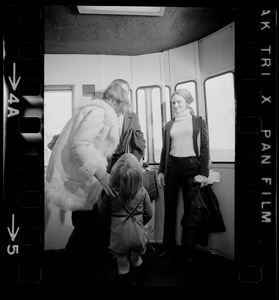 Elisabeth Neumann, freed recently from East German prison, and her fiancé, Lyle Jenkins, MIT student who flew to Germany to meet her on her release, are greeted at Logan Airport by Jenkins' nephew, Saarin Auker, 3, of Cambridge, a bearer of red roses