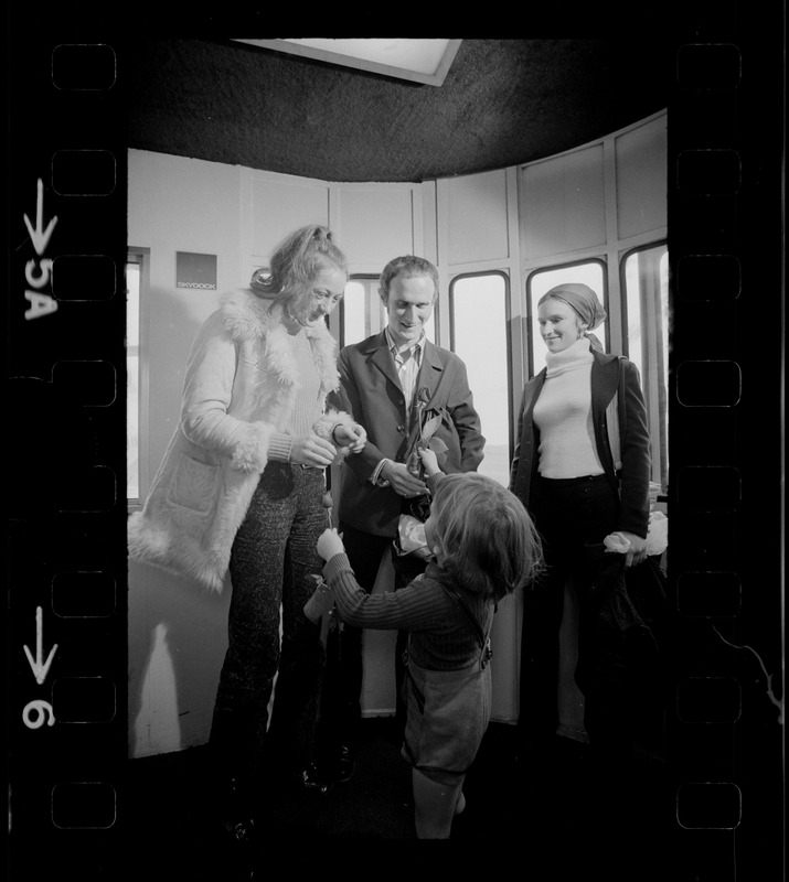 Elisabeth Neumann, freed recently from East German prison, and her fiancé, Lyle Jenkins, MIT student who flew to Germany to meet her on her release, are greeted at Logan Airport by Jenkins' nephew, Saarin Auker, 3, of Cambridge, a bearer of red roses