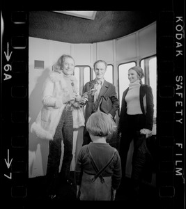 Elisabeth Neumann, freed recently from East German prison, and her fiancé, Lyle Jenkins, MIT student who flew to Germany to meet her on her release, are greeted at Logan Airport by Jenkins' nephew, Saarin Auker, 3, of Cambridge, a bearer of red roses