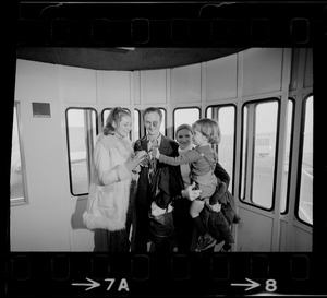 Elisabeth Neumann, freed recently from East German prison, and her fiancé, Lyle Jenkins, MIT student who flew to Germany to meet her on her release, are greeted at Logan Airport by Jenkins' nephew, Saarin Auker, 3, of Cambridge, a bearer of red roses