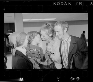 Elisabeth Neumann, freed recently from East German prison, and her fiancé, Lyle Jenkins, MIT student who flew to Germany to meet her on her release, are greeted at Logan Airport by Jenkins' nephew, Saarin Auker, 3, of Cambridge, a bearer of red roses