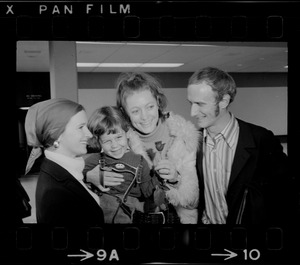 Elisabeth Neumann, freed recently from East German prison, and her fiancé, Lyle Jenkins, MIT student who flew to Germany to meet her on her release, are greeted at Logan Airport by Jenkins' nephew, Saarin Auker, 3, of Cambridge, a bearer of red roses