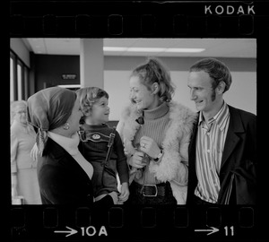 Elisabeth Neumann, freed recently from East German prison, and her fiancé, Lyle Jenkins, MIT student who flew to Germany to meet her on her release, are greeted at Logan Airport by Jenkins' nephew, Saarin Auker, 3, of Cambridge, a bearer of red roses