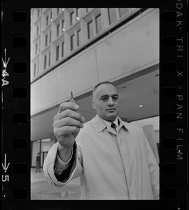 Former Massachusetts Lieut. Gov. Francis Bellotti at Government Center holding 47 cent key he claims will open any filing cabinet