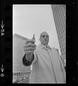 Former Massachusetts Lieut. Gov. Francis Bellotti at Government Center holding 47 cent key he claims will open any filing cabinet