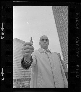 Former Massachusetts Lieut. Gov. Francis Bellotti at Government Center holding 47 cent key he claims will open any filing cabinet