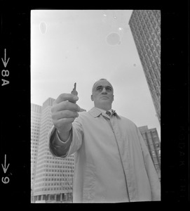 Former Massachusetts Lieut. Gov. Francis Bellotti at Government Center holding 47 cent key he claims will open any filing cabinet