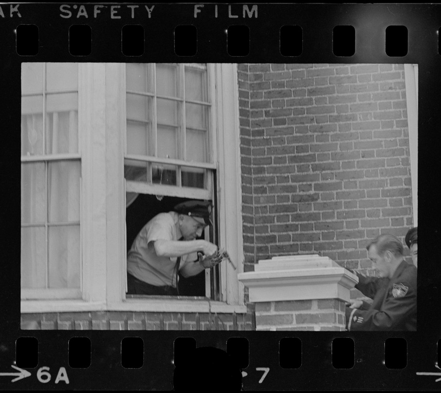 Police climb through window of house looking for suspects following an ...