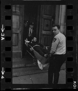 Robert Barry on stretcher after breaking ankles during attempt to escape Charles Street Jail