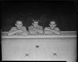 Three swimmers at the side of McCurdy Natatorium