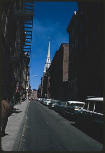 Partial view of Old North Church steeple at end of street