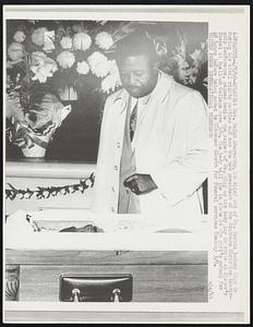 Rev. Ralph Abernathy, the chief aid of Dr. Martin Luther King Jr during his civil rights battles and now the new president of the Southern Christian Leadership Conference, pauses beside the casket of Dr. King as his body lay in state at Sister’s Chapel at Spellman College here 3/6. The body will lie in state at the girl’s school for 48 hours before being moved to Ebenezer Church for funeral services Thursday 3/9.