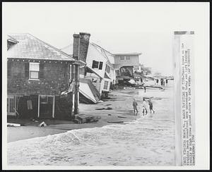 Victims of Tide-These homes on the Virginia Beach oceanfront were undermined today and left leaning crazily by high tides pushed ashore by gale winds.