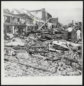 Tornado Wrecks Downtown Waco-This is a view up Franklin avenue of the Texas city after a twister had ripped through the business district. The street is under several feet of parts of demolished buildings and cars.