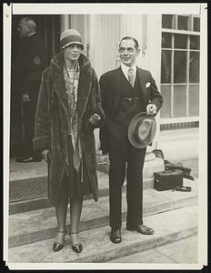 Miss Amelia Earhardt, first woman to fly across the Atlantic, photographed at the White House in Washington today after a short call on President Coolidge. Porter Adams of the National Aeronautic Association is seen with Miss Earhardt.