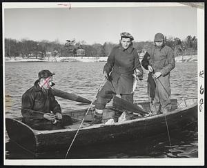 First One of The Season-Billy Folsom of Milton gives the cameraman a peek at his first catch of the season as the fishing season got underway today. Joe Leona of Roxbury (right) also tries his luck at Jamaica Pond.