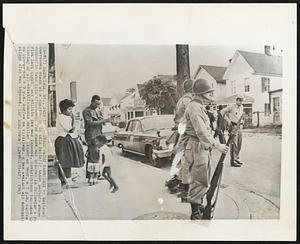 Check Point Cambridge -- National Guardsmen stand at a checkpoint in this racially tense Eastern Shore community late this afternoon. The guard was ordered in following a race riot last night, and militia law was imposed. Restrictions included the closing of all establishments selling liquor or beer, a 7 p.m. curfew on store and a 9 p.m. curfew on civilians. A ban against all demonstrations also was imposed.