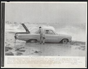 St. Petersburg Out. A motorist who waited just a little too long as Hurricane Gladys headed toward a landfall tonight (10/18) on Florida's West Coast finds his car hopelessly mired down in wet sand as the pounding surf hits municipal beach here.
