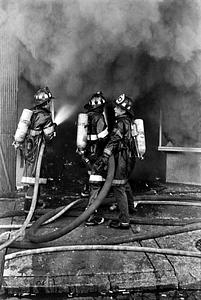 Boston firefighters advancing an attack line into the fire building during the JJ Newberry Fire