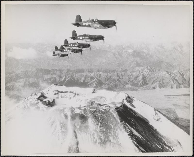 Corsairs of "Hell's Bells" Squadron, a unit of Marine Air Group 31, flying a surveillance patrol