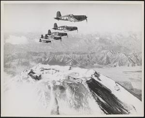 Corsairs of "Hell's Bells" Squadron, a unit of Marine Air Group 31, flying a surveillance patrol