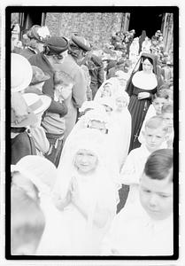 A group of children coming out of a church after their first Communion