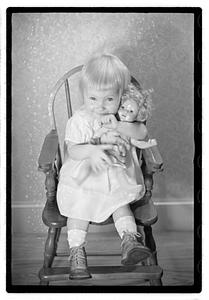 A girl holding a doll