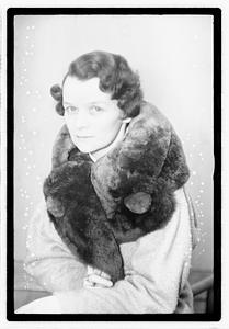 A woman with a fur scarf around her neck