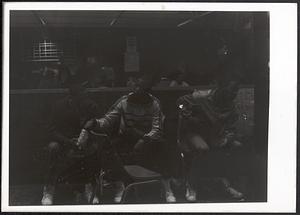 Young men sitting and eating snacks