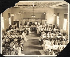 Group of seamstresses with clothing on display