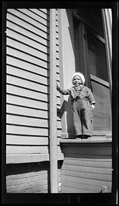 Toddler standing on a porch