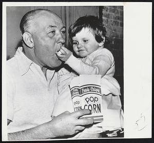 That Must be Grandpopcorn - Although Jack Sharkey is not the grandfather of 3-year-old Betsy Snow of South Portland. The former world heavyweight champion was in Portland to referee a wrestling show and he met the young lady. She thereby wanted Jack, who is a grandfather, to share in her popcorn and he did.