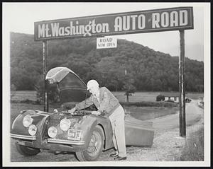 Getting Set For Race Up Mt. Washington -- Doctor Francis McAppleton of Gorham, N.H., checks his Jaguar for a test run up Mt. Washington where he and other sport car enthusiasts will take part in the second annual “Race to the Clouds” this weekend, (Aug. 14-15). It’s eight miles of winding road from the base to the top of New England’s highest peak.