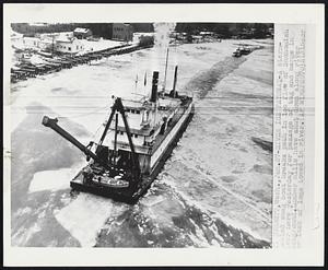 River Ice Pathway- A stern-wheeled snag boat breaks in ice flow of Snohomish river here yesterday for passage of tug and barge in background. Lumber mills have shut down along river or lack of logs towed in river.