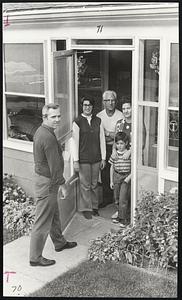 Gil Durand, a GM material handler, returns home from picket duty. Standing in the doorway of his Marlboro house are, from left to right, Dolores, his fifteen year old daughter, Armond Trota, his father-in-law, his wife Antoinette and seven year old son Michael.