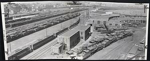 Strike-bound East Cambridge Yards of Boston & Maine railroad show hundreds of locomotives, coaches and coal cars idle. Yard roundhouse, at right, is filled with locomotives.