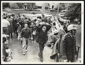 Lexington Police Officer leads Anti-Vietnam Veterans and sympathizers into Concord. District Court for arraignment. Charge: Violating the town. curfew.