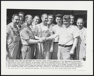 Motormen Who Started Subway Strike -- Members of the Motormen's Benevolent Association give their support to motormen Jack Roth, checkered shirt, and John P. Sweeney, center, after their suspension triggered the strike which crippled New York's subway system. Vernon Deyo, unit chairman, shakes their hands and assures them union backing at Brooklyn meeting. Roth, Sweeney and another motorman were suspended when they refused to take supervisory personnel on practice run over parts of the underground system.