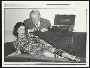 She lies! Through the stethoscope Dr. Marston detects the subject's heightened breathing as she tries to keep the truth from him.