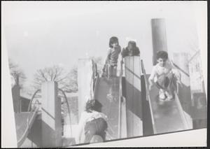 Children playing on slides at a playground